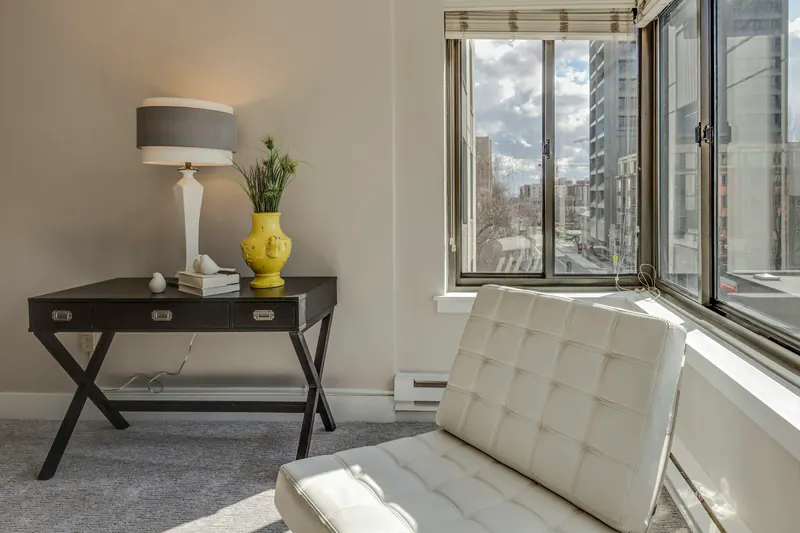Reference photograph: a white chair beside a full-height window and a small dark console.